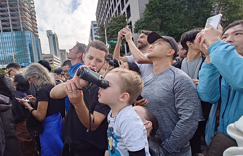 Az épület lábánál bámészkodók tömege nézi, amint Alex Honnold megméretteti a Taipei 101 felhőkarcolót 2026. január 25-én